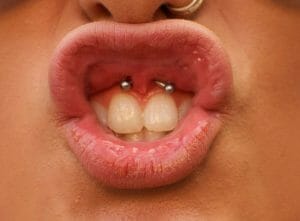 Lip frenulum piercing closeup